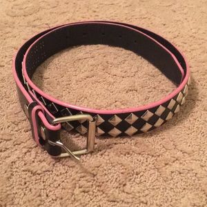 Tilt black studded belt with pink trim. Size M.